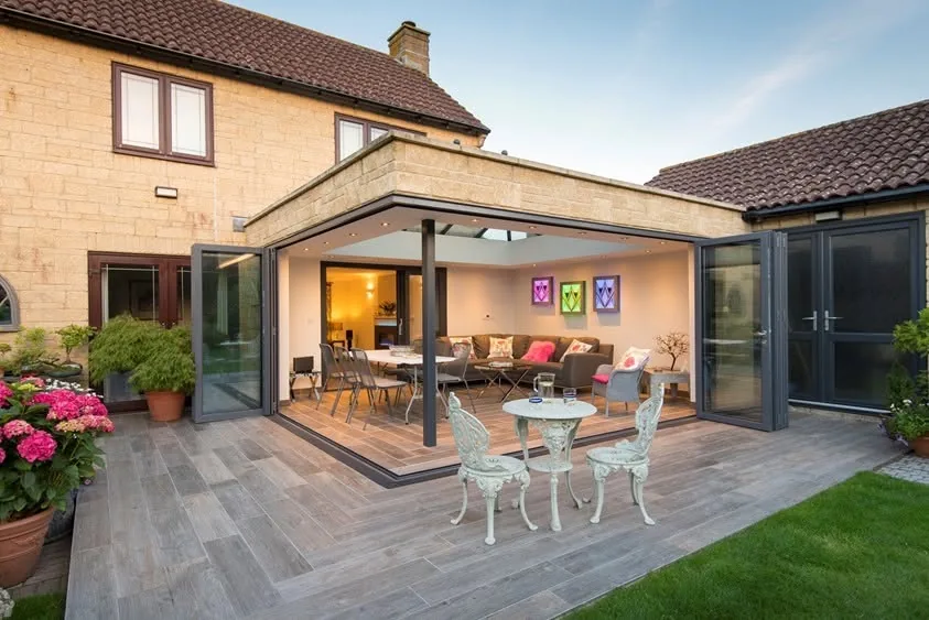 Stone fronted rear extension with bi-fold doors onto a patio