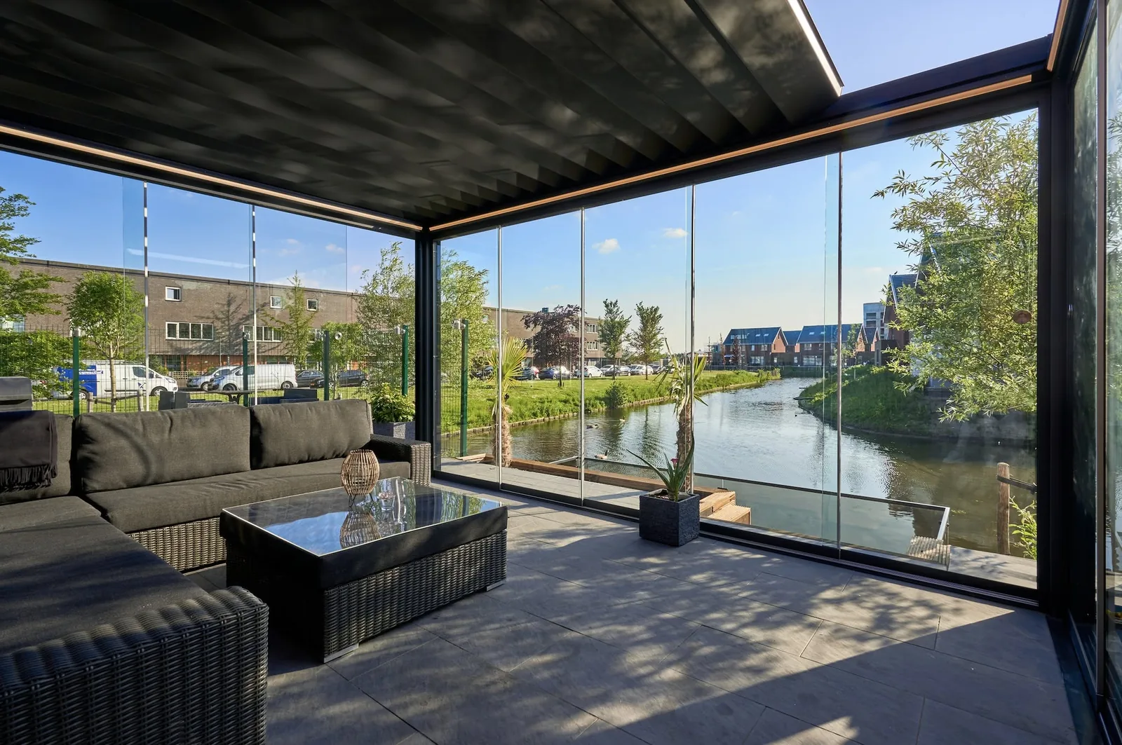Glazed pergola extension interior looking out over water